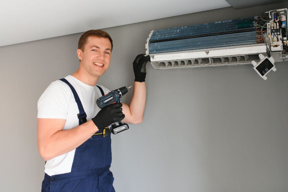 A man and woman are fixing an air conditioner, showcasing appliance repair services available in Washington, DC.